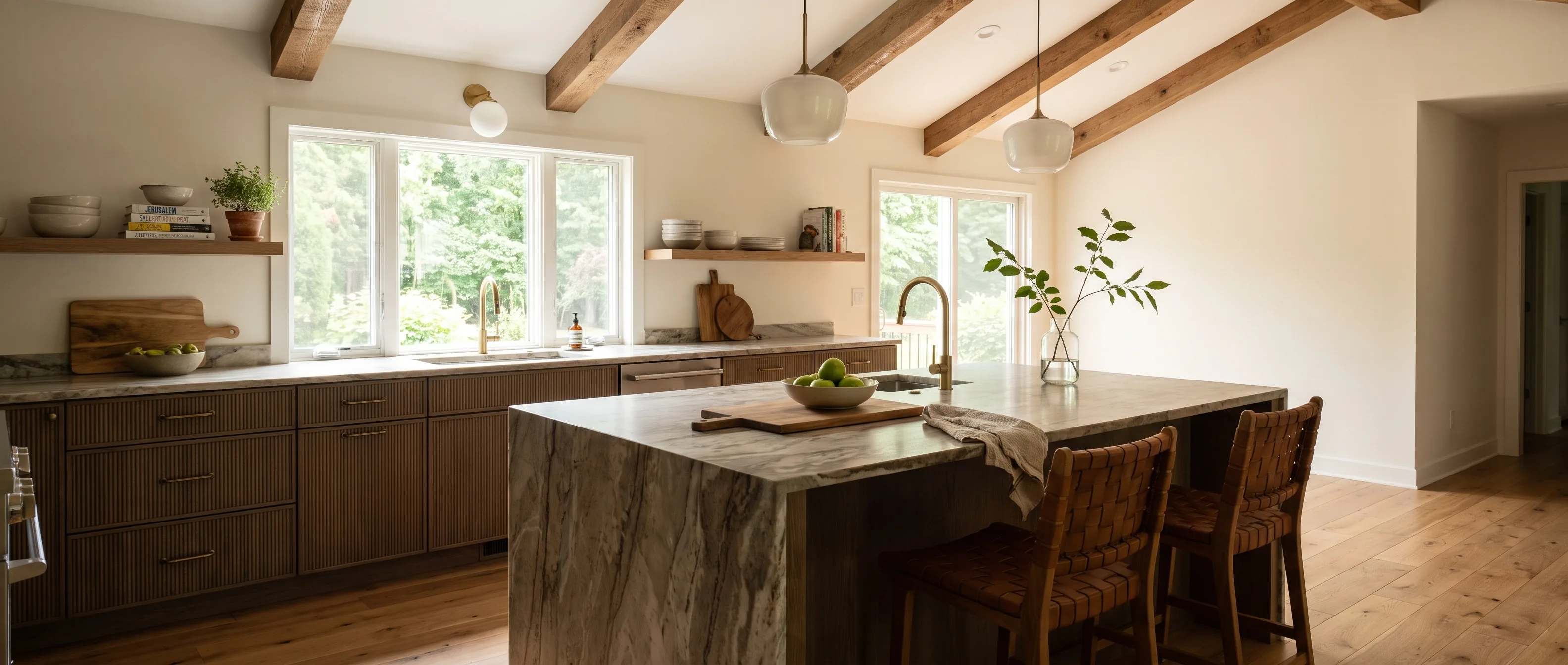 Kitchen remodel in Bethlehem Township, PA — smoked-oak fluted cabinetry under exposed wood beams, a veined-quartzite island, bronze hardware | VM Power Kitchen & Bath